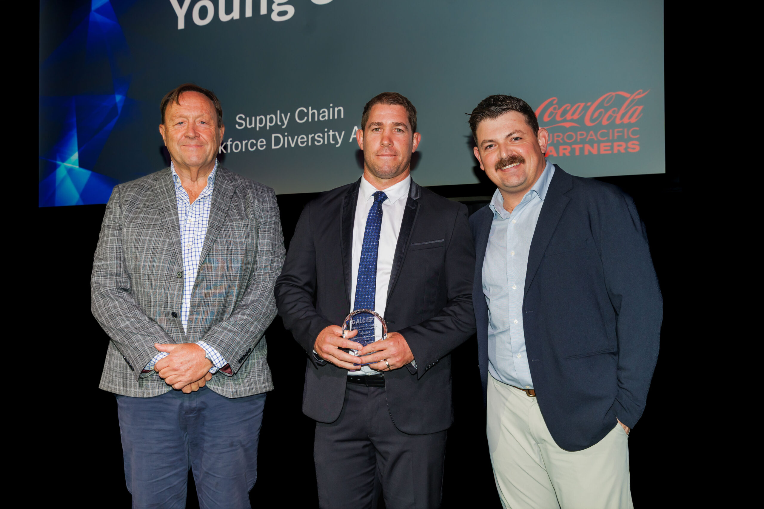 Three people accepting the ALC award